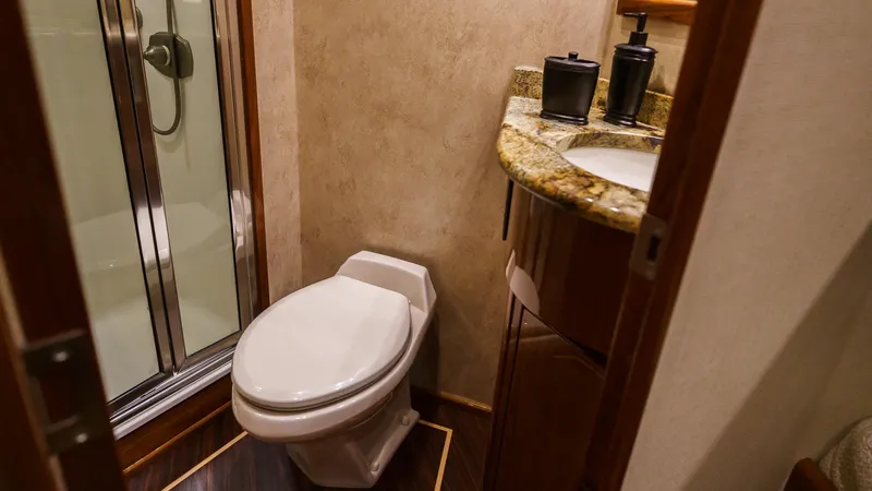 Benedetta Yacht Photos Pics Bathroom interior of 2012 Viking 70 Enclosed Bridge yacht with shower and granite countertop.