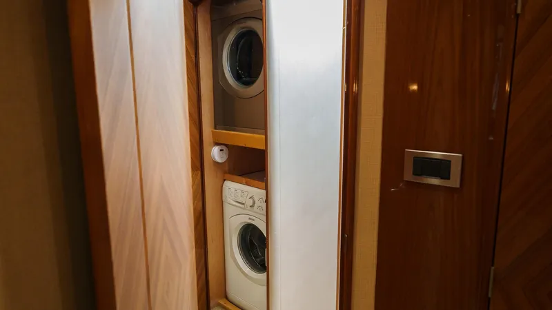Benedetta Yacht Photos Pics Stacked washer and dryer in 2012 Viking 70 Enclosed Bridge yacht interior.
