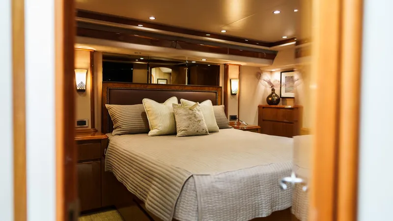 Benedetta Yacht Photos Pics Luxurious bedroom interior of 2012 Viking 70 Enclosed Bridge yacht with elegant bedding.