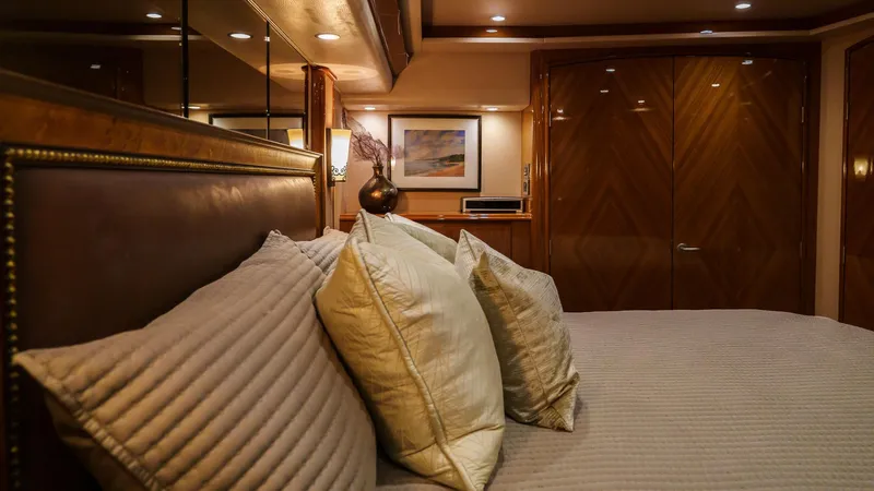 Benedetta Yacht Photos Pics Luxurious bedroom interior of 2012 Viking 70 Enclosed Bridge yacht with elegant decor.