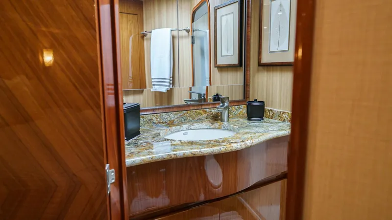 Benedetta Yacht Photos Pics Luxurious bathroom in 2012 Viking 70 Enclosed Bridge yacht with granite countertop.