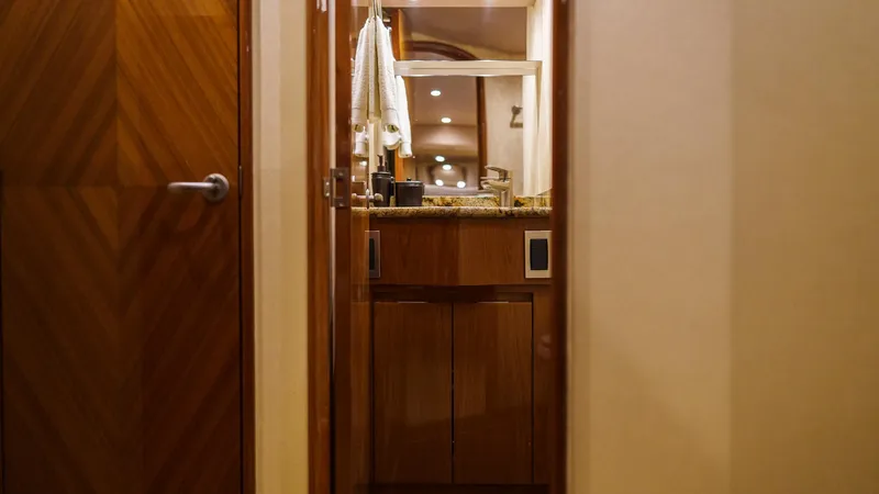 Benedetta Yacht Photos Pics Luxurious bathroom interior of 2012 Viking 70 Enclosed Bridge yacht, featuring wooden cabinetry.