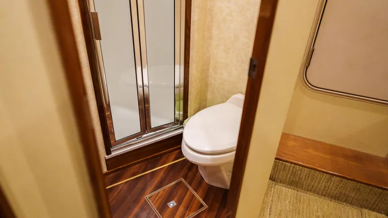 Benedetta Yacht Photos Pics Bathroom interior of 2012 Viking 70 Enclosed Bridge yacht with shower and toilet.