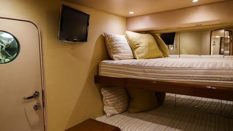 Benedetta Yacht Photos Pics Interior of 2012 Viking 70 Enclosed Bridge yacht with bunk beds and TV.
