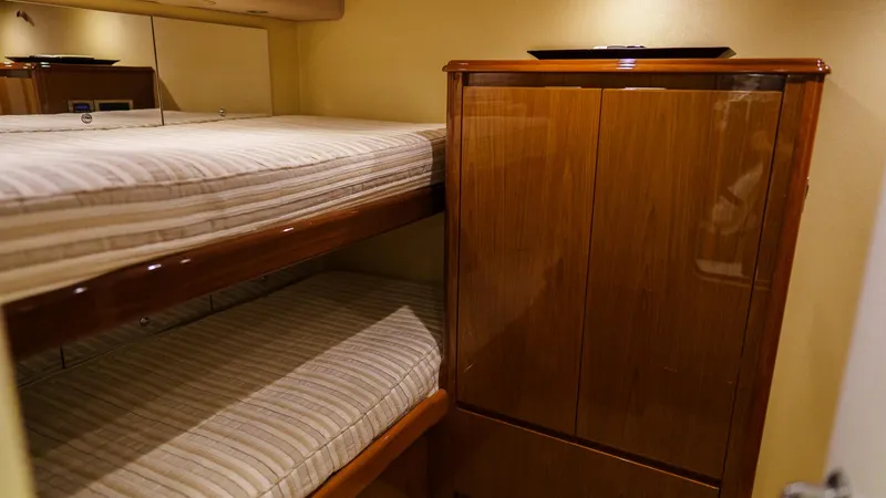 Benedetta Yacht Photos Pics Bunk beds and wooden cabinet in 2012 Viking 70 Enclosed Bridge yacht interior.