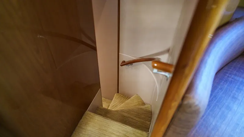 Benedetta Yacht Photos Pics Staircase inside 2012 Viking 70 Enclosed Bridge yacht with wooden handrail.