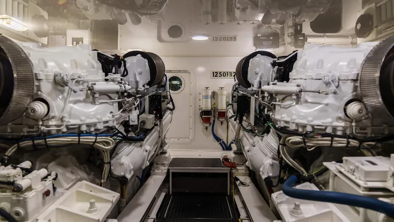 Benedetta Yacht Photos Pics Engine room of 2012 Viking 70 Enclosed Bridge yacht, featuring dual engines and mechanical systems.