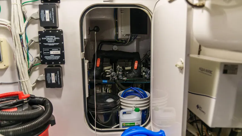 Benedetta Yacht Photos Pics Engine room of 2012 Viking 70 Enclosed Bridge with equipment and maintenance supplies.