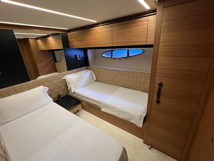  Yacht Photos Pics Luxurious cabin interior of a 2012 Pershing 92 yacht with twin beds and wooden finishes.