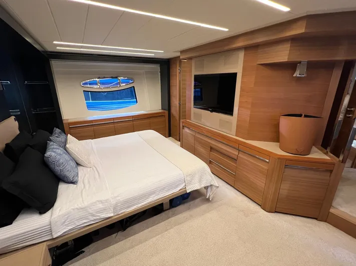  Yacht Photos Pics Luxurious bedroom interior of a 2012 Pershing 92 yacht with modern wood finishes.