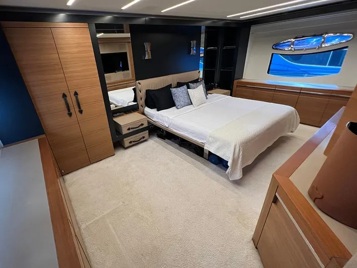  Yacht Photos Pics Luxurious bedroom interior of a 2012 Pershing 92 yacht with modern furnishings.