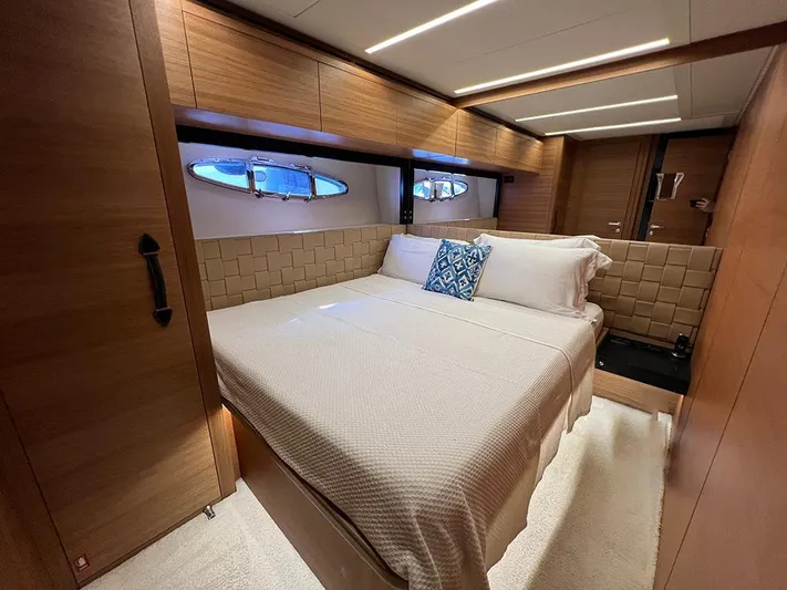  Yacht Photos Pics Luxurious bedroom interior of a 2012 Pershing 92 yacht with elegant wood finishes.