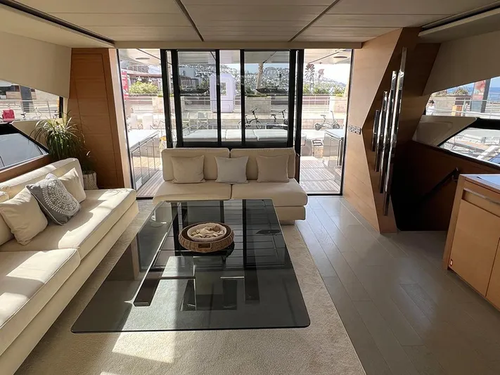  Yacht Photos Pics Luxurious interior of a 2012 Pershing 92 yacht with modern furnishings and glass table.