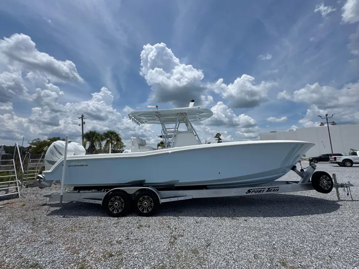  Yacht Photos Pics 2017 Invincible 33 Open Fisherman boat on trailer under cloudy sky.