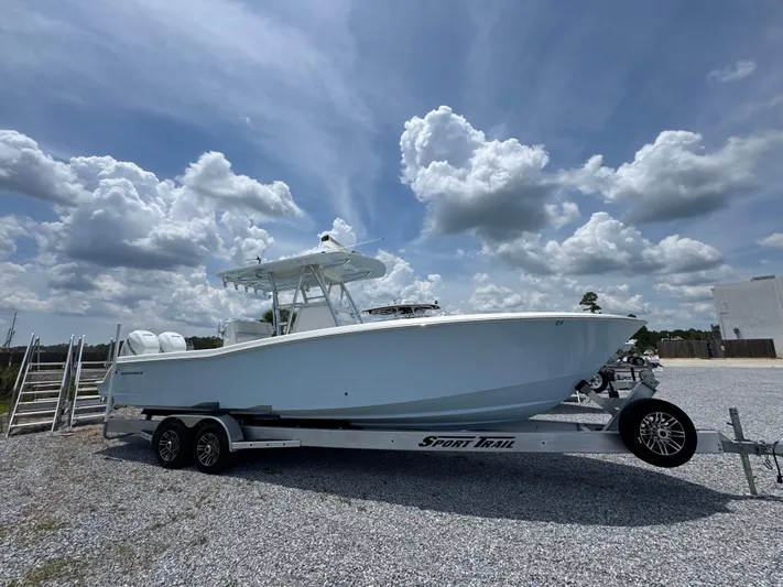  Yacht Photos Pics 2017 Invincible 33 Open Fisherman boat on trailer under cloudy sky.