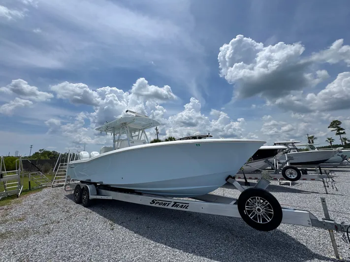  Yacht Photos Pics 2017 Invincible 33 Open Fisherman boat on trailer under cloudy sky.
