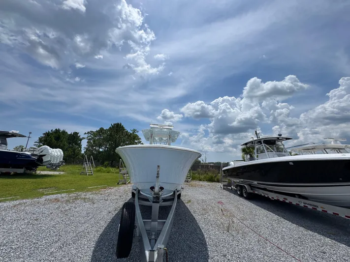  Yacht Photos Pics 2017 Invincible 33 Open Fisherman boat on trailer under cloudy sky.