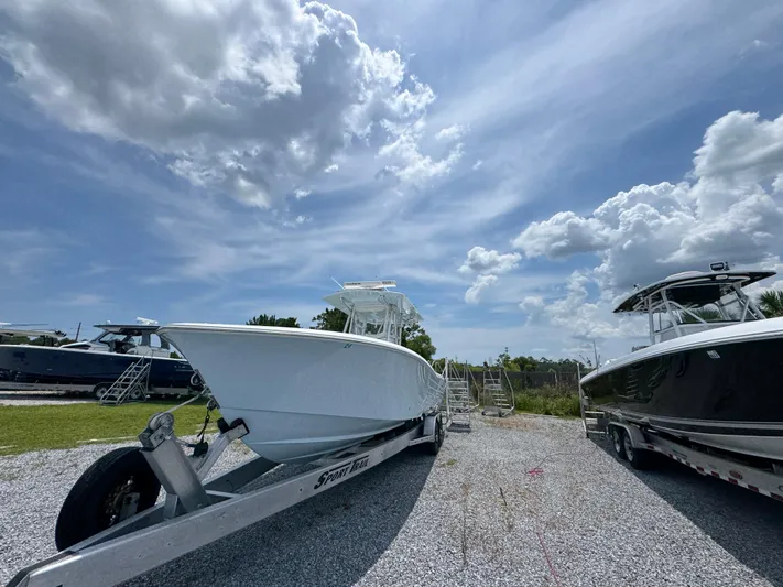  Yacht Photos Pics 2017 Invincible 33 Open Fisherman boat on trailer under cloudy sky.