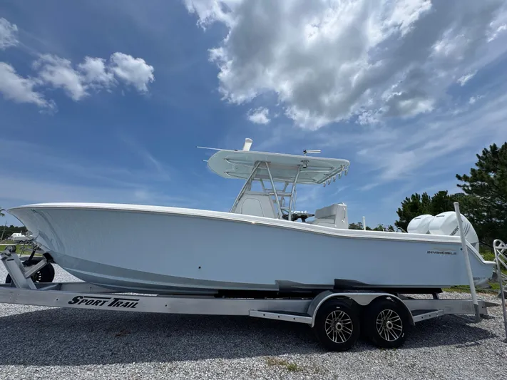  Yacht Photos Pics 2017 Invincible 33 Open Fisherman boat on trailer under blue sky.