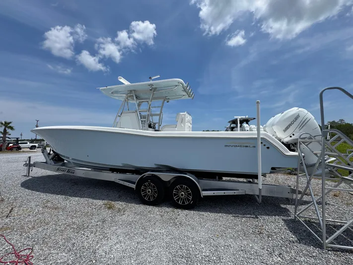  Yacht Photos Pics 2017 Invincible 33 Open Fisherman boat on trailer under blue sky.