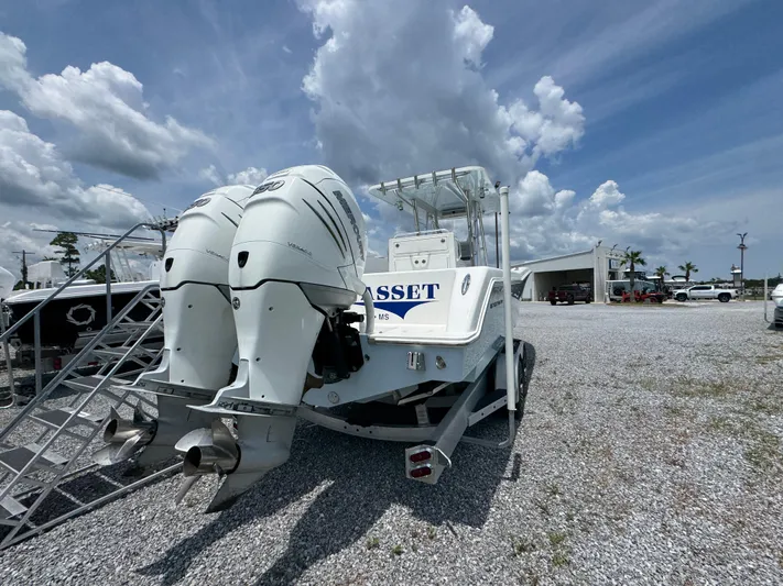  Yacht Photos Pics 2017 Invincible 33 Open Fisherman boat with dual outboard engines on gravel lot.