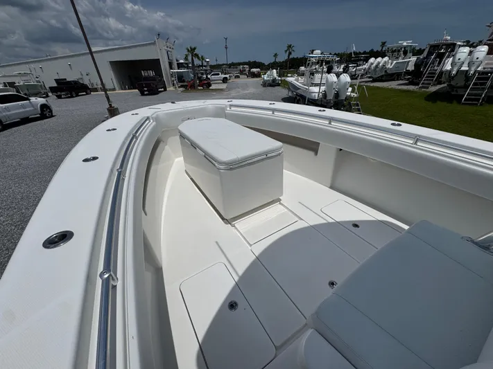  Yacht Photos Pics 2017 Invincible 33 Open Fisherman boat interior with seating and storage, parked outdoors.