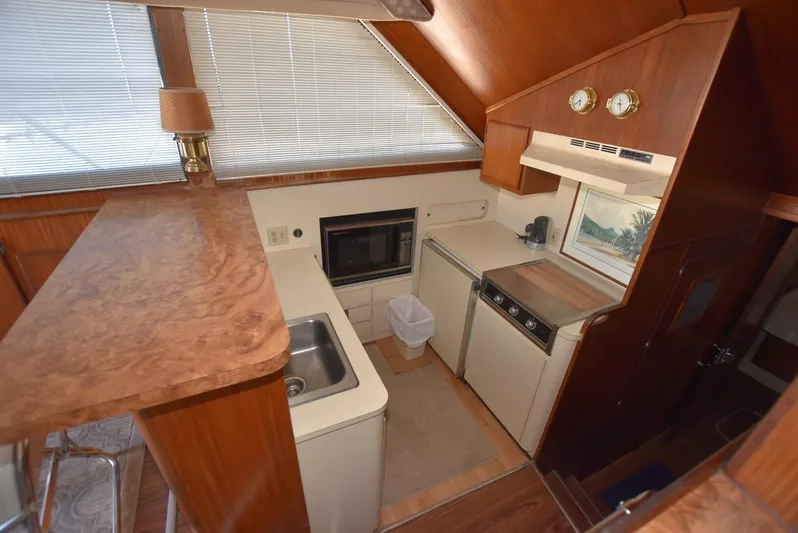 Russell Hatt Yacht Photos Pics 1988 Hatteras 48 Convertible yacht kitchen with wood finish and modern appliances.