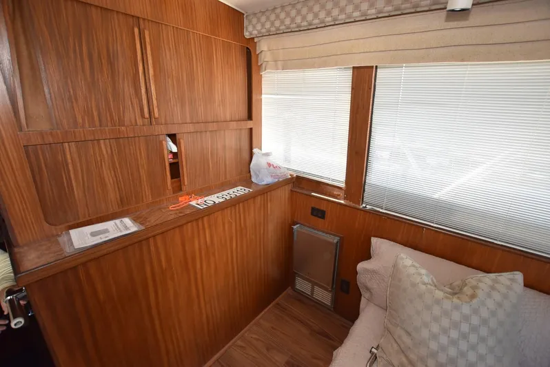 Russell Hatt Yacht Photos Pics Interior of 1988 Hatteras 48 Convertible yacht with wood paneling and window blinds.