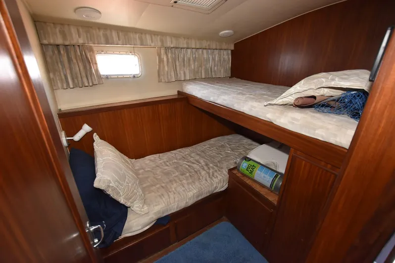 Russell Hatt Yacht Photos Pics 1988 Hatteras 48 Convertible cabin with wooden bunk beds and window.