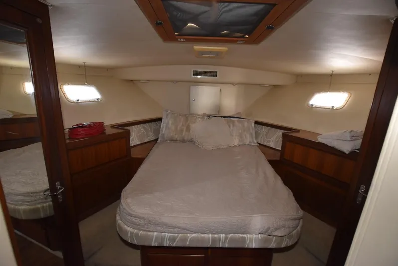 Russell Hatt Yacht Photos Pics Interior cabin of 1988 Hatteras 48 Convertible yacht with bed and windows.