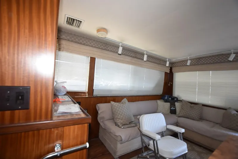 Russell Hatt Yacht Photos Pics Interior of 1988 Hatteras 48 Convertible yacht with cozy seating and wooden accents.