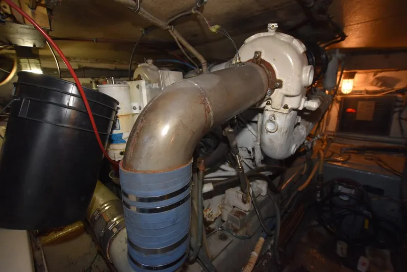 Russell Hatt Yacht Photos Pics Engine room of 1988 Hatteras 48 Convertible yacht, showcasing mechanical components.