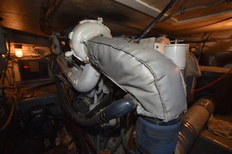 Russell Hatt Yacht Photos Pics Engine room of 1988 Hatteras 48 Convertible yacht, showcasing mechanical components.