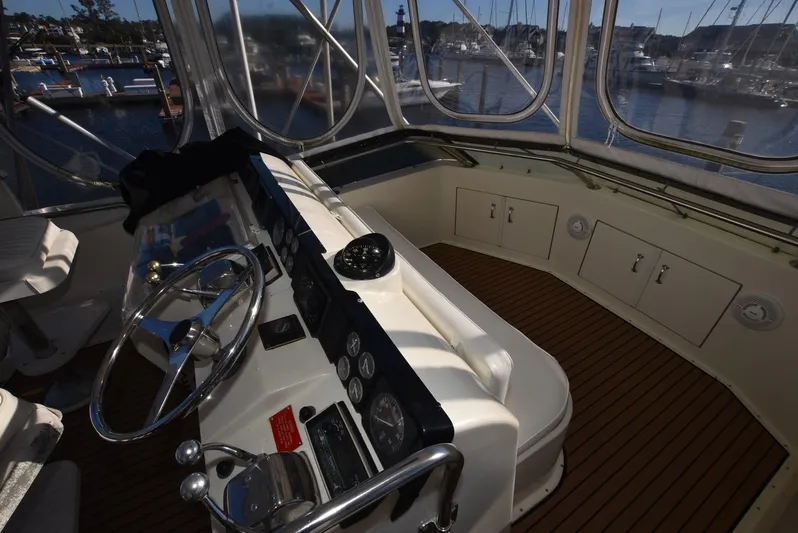 Russell Hatt Yacht Photos Pics 1988 Hatteras 48 Convertible yacht helm with steering wheel and gauges, docked at marina.