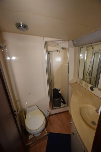 Russell Hatt Yacht Photos Pics 1988 Hatteras 48 Convertible yacht bathroom with shower, sink, and toilet.