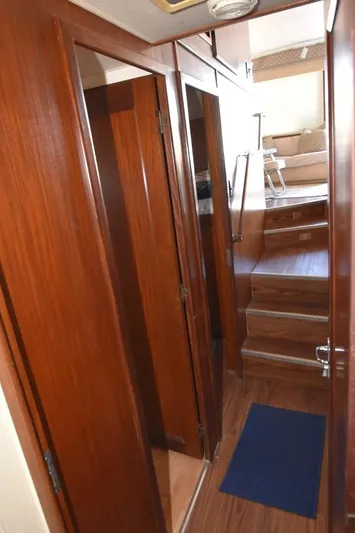 Russell Hatt Yacht Photos Pics Interior view of 1988 Hatteras 48 Convertible yacht with wooden finishes and stairs.