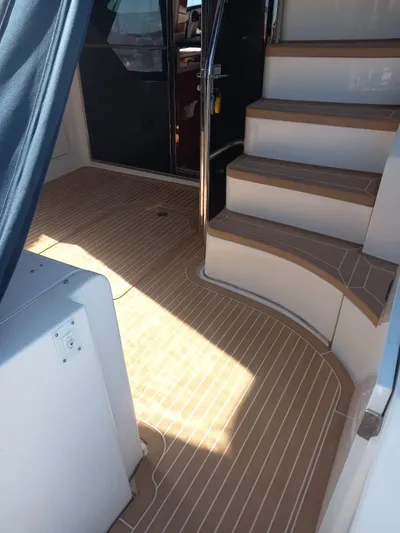  Yacht Photos Pics 2009 Sea Ray 505 Sedan Bridge yacht interior with wooden flooring and staircase.