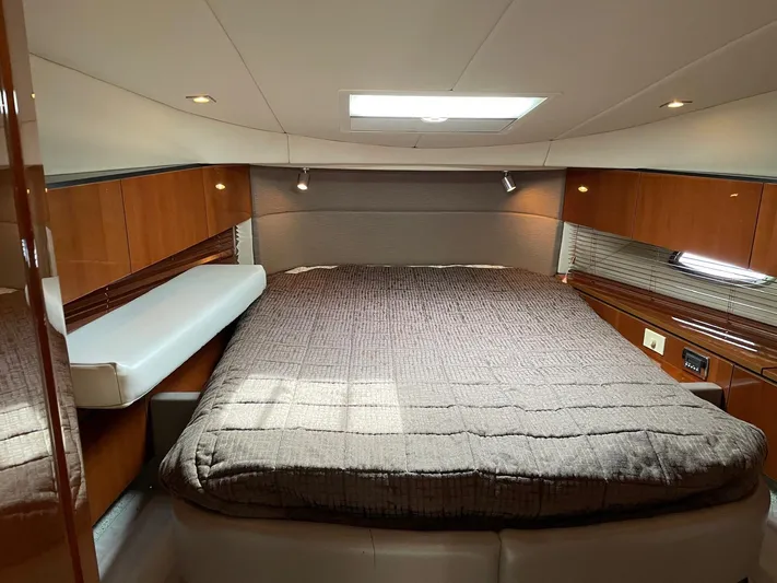  Yacht Photos Pics Luxurious cabin interior of 2009 Sea Ray 505 Sedan Bridge yacht with cozy bed and wood paneling.