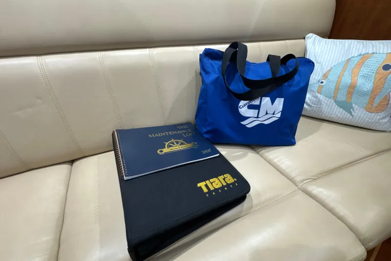 Blue Sky Yacht Photos Pics 2006 Tiara Yachts 3600 Sovran maintenance log and bag on beige leather seat.