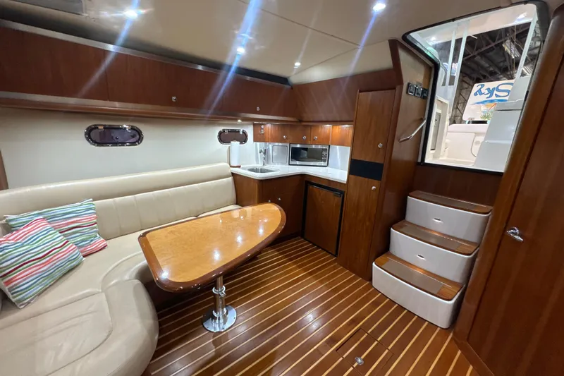 Blue Sky Yacht Photos Pics 2006 Tiara Yachts 3600 Sovran interior with wood finish, kitchenette, and seating area.