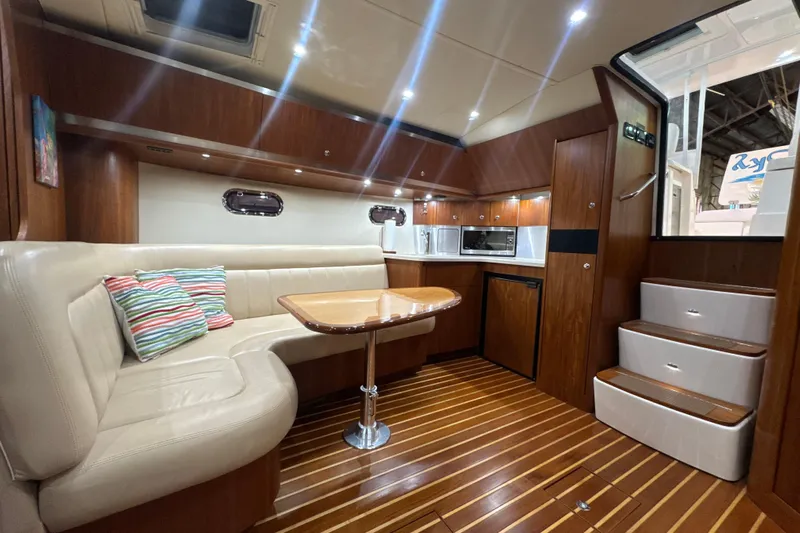 Blue Sky Yacht Photos Pics Luxurious 2006 Tiara Yachts 3600 Sovran interior with elegant wood finish and cozy seating.