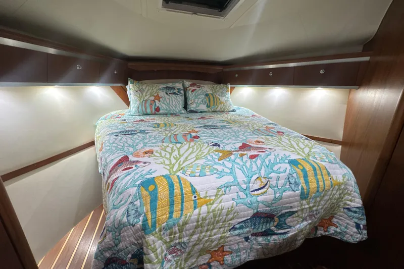 Blue Sky Yacht Photos Pics 2006 Tiara Yachts 3600 Sovran cabin with nautical-themed bedding and ambient lighting.