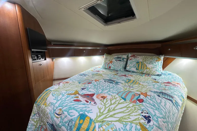 Blue Sky Yacht Photos Pics 2006 Tiara Yachts 3600 Sovran cabin with colorful marine-themed bedding and wood accents.