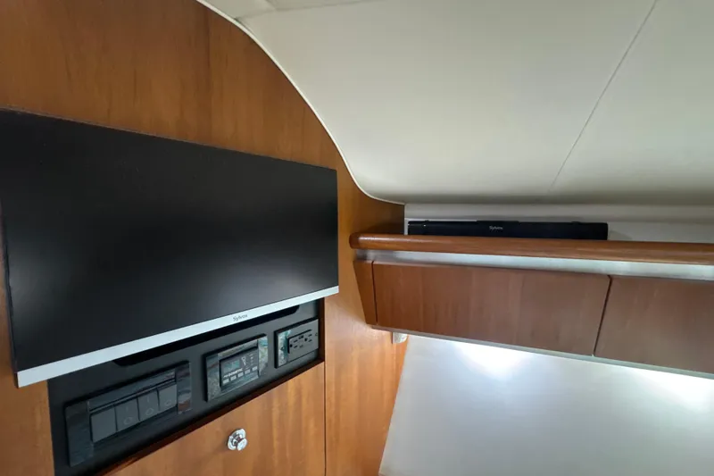 Blue Sky Yacht Photos Pics Interior of 2006 Tiara Yachts 3600 Sovran with TV and wooden cabinetry.