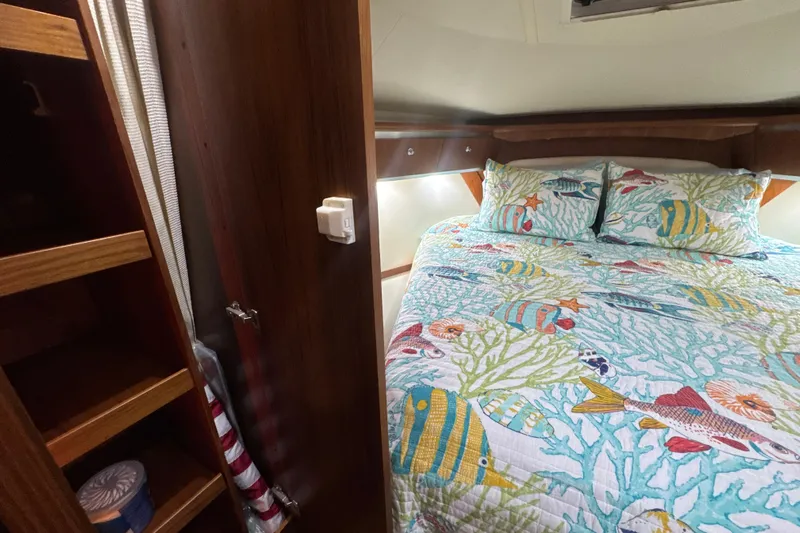 Blue Sky Yacht Photos Pics Cozy cabin interior of 2006 Tiara Yachts 3600 Sovran with nautical-themed bedding.