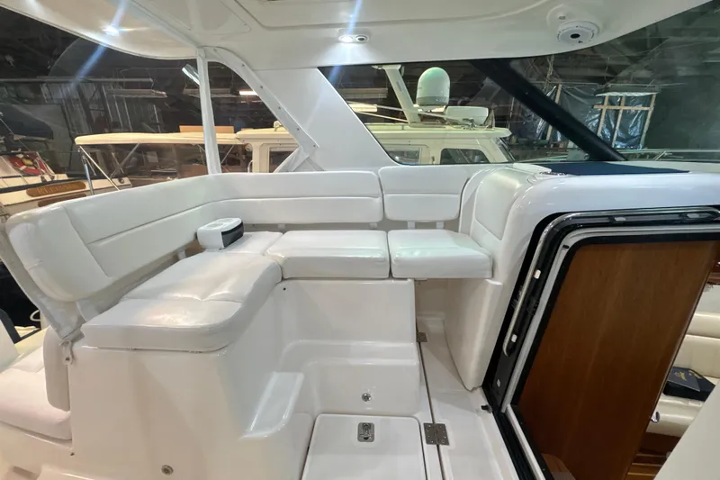Blue Sky Yacht Photos Pics 2006 Tiara Yachts 3600 Sovran interior with white seating and wooden accents.