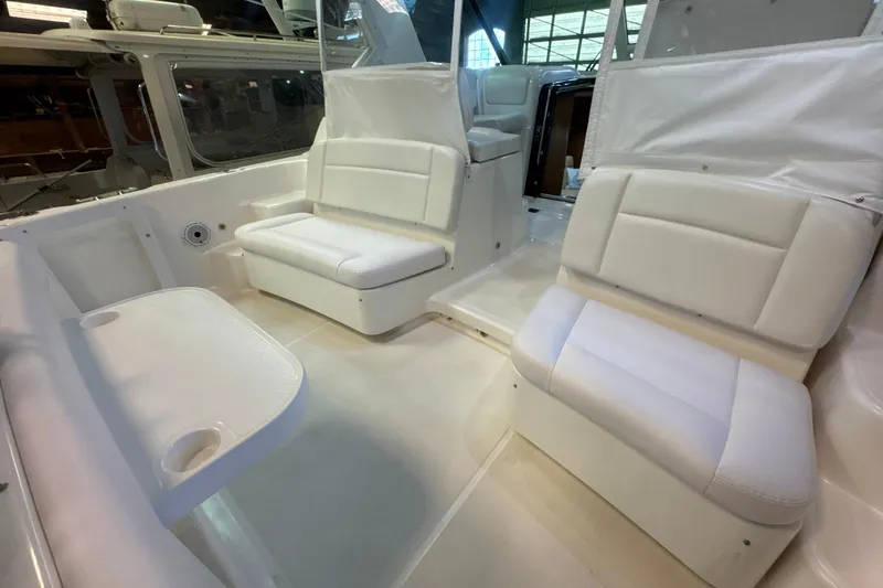 Blue Sky Yacht Photos Pics 2006 Tiara Yachts 3600 Sovran interior with white seating and table.