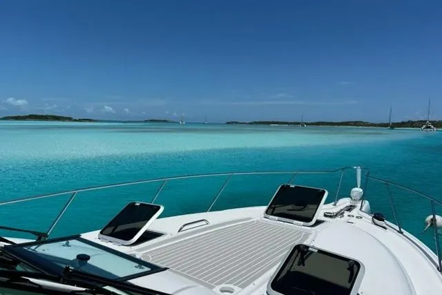 Blue Sky Yacht Photos Pics 2006 Tiara Yachts 3600 Sovran cruising on clear turquoise waters under a blue sky.