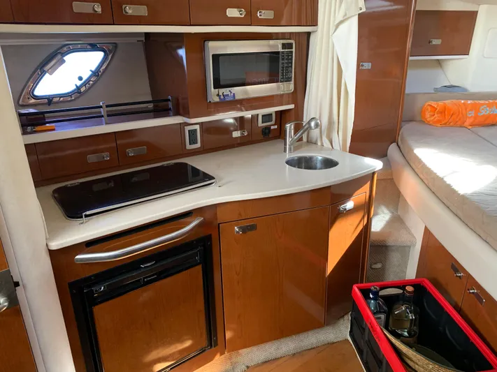 Summer Of Bob Yacht Photos Pics 2011 Sea Ray 330 Sundancer interior kitchen with microwave, sink, and stove.