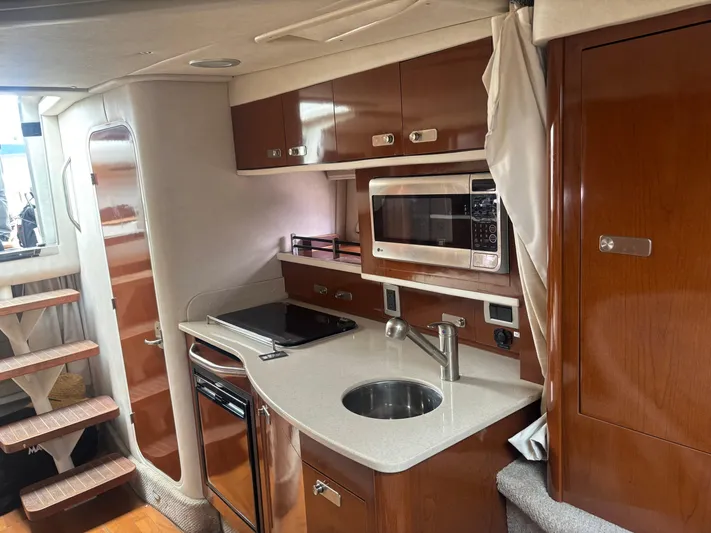 Summer Of Bob Yacht Photos Pics Interior of 2011 Sea Ray 330 Sundancer yacht with modern kitchen amenities.